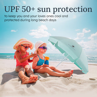 Two children on a beach with sun protection products and an umbrella, promoting UPF 50+ sun protection.