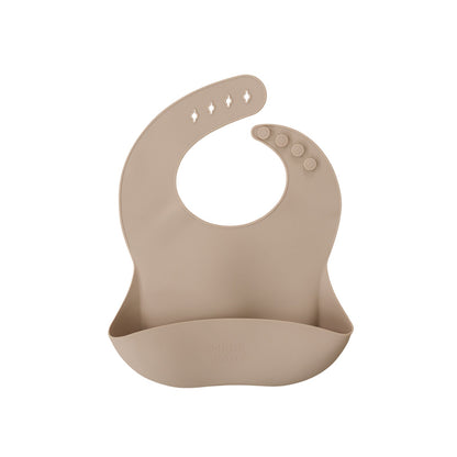 Beige silicone bib on a white background