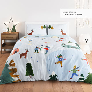 Children's bedding set with winter-themed design on a bed in a room.