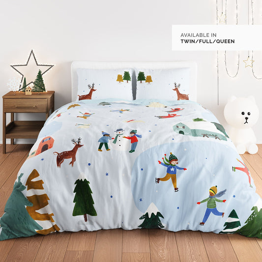 Children's bedding set with winter-themed design on a bed in a room.