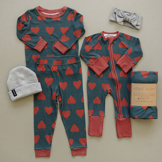Children's onesie with red heart pattern on a blue background