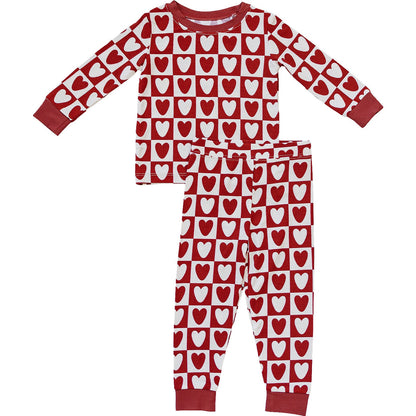 Red and white heart-patterned pajama set on a white background