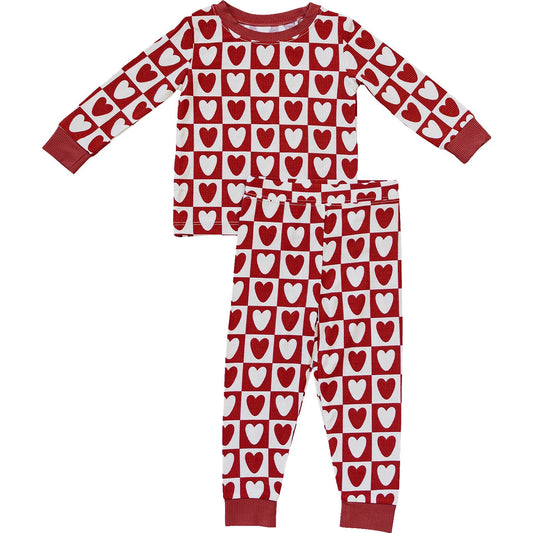 Red and white heart-patterned pajama set on a white background