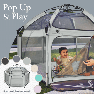 Pop-up play tent with a child inside, set against a natural background.