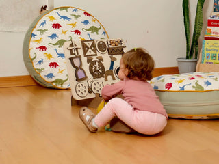 Child playing with educational toys on a wooden floor