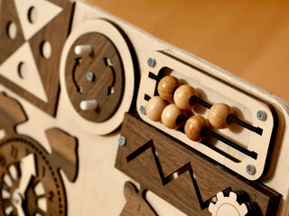 Wooden abacus with gears on a wooden background