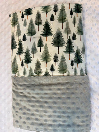 Fabric with tree pattern and gray pocket on a textured background