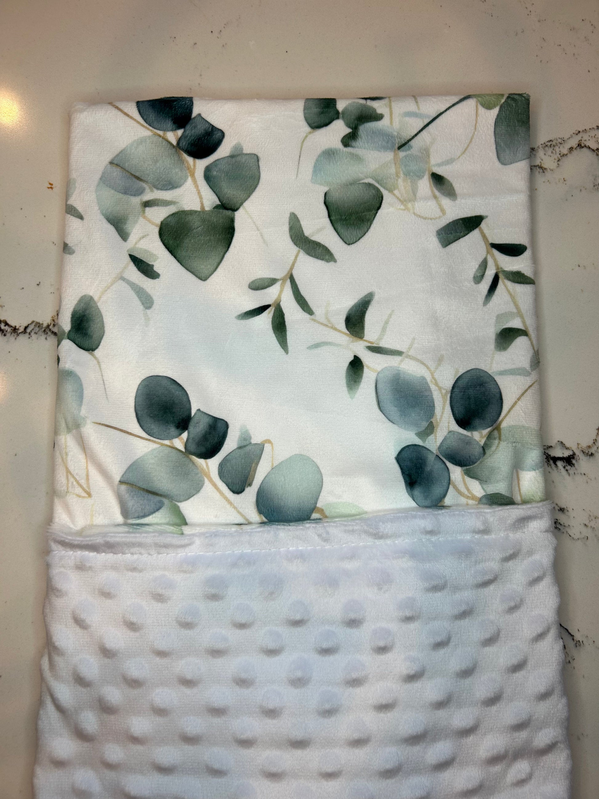 Floral-patterned fabric with green leaves on a white background