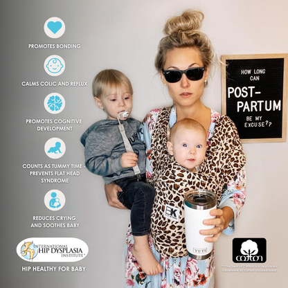 A woman with two children snug in a leopard print Baby K'tan carrier, embodying comfort and style in parenting.
