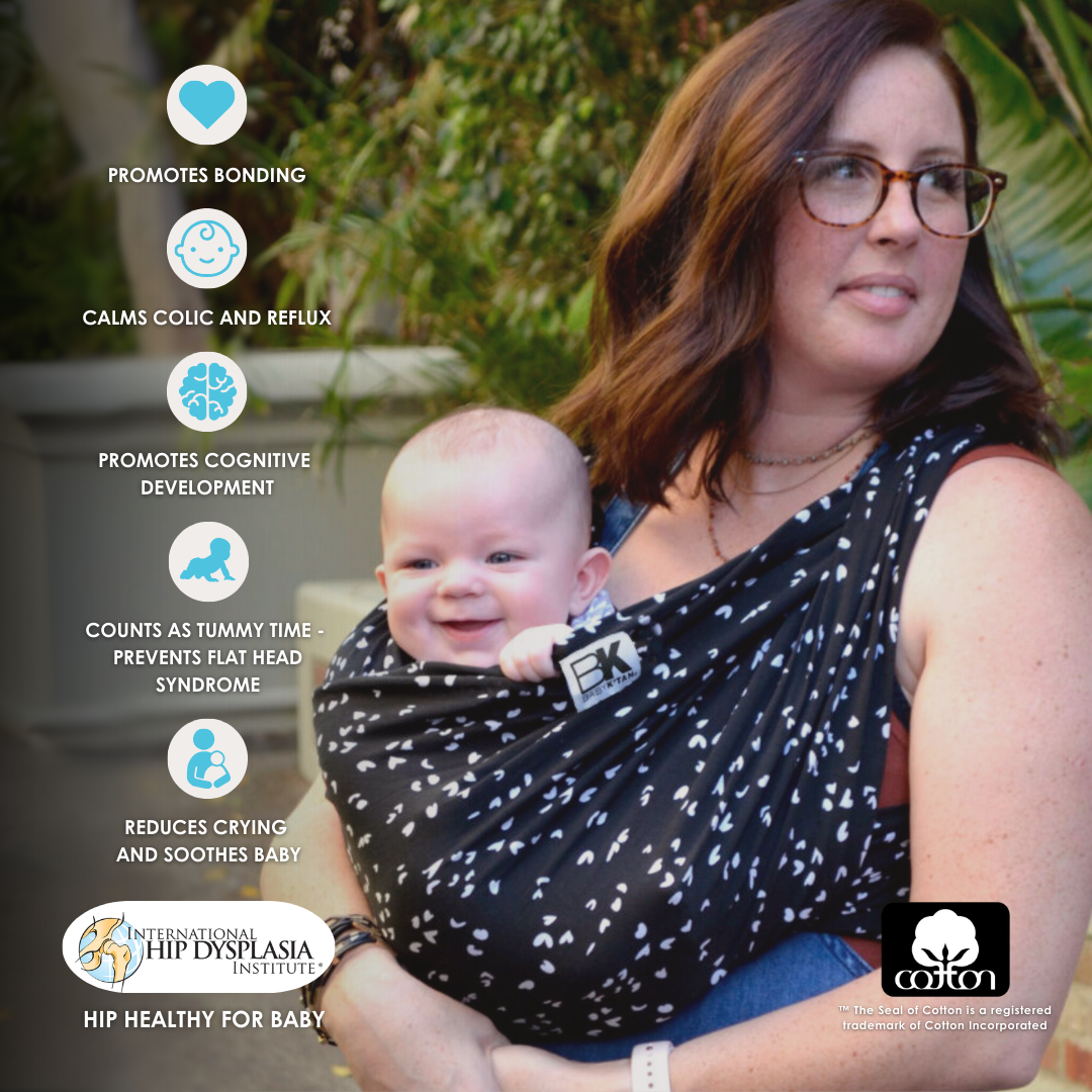 A women with a baby in a black and white plaid Baby K'tan carrier, illustrating a loving and supportive parenting moment.