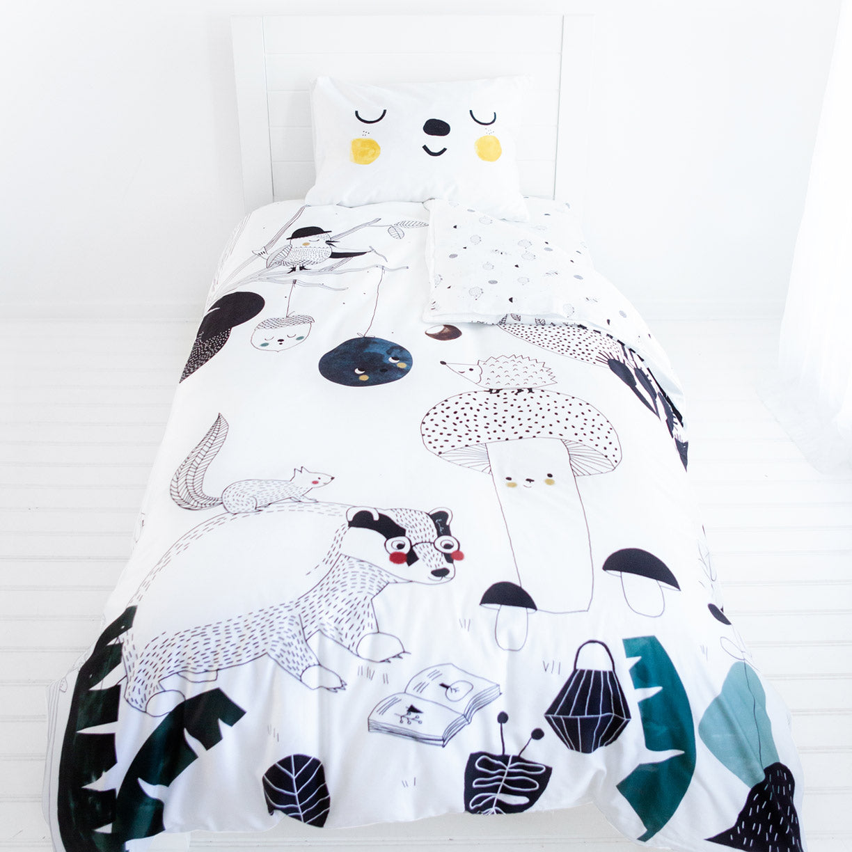 Children's bedding set with animal and nature-themed design on a white background