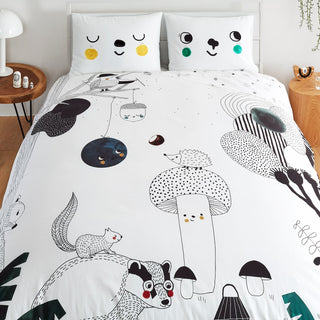 A bed featuring a white comforter adorned with a playful cartoon animal design, suitable for a child's room.
