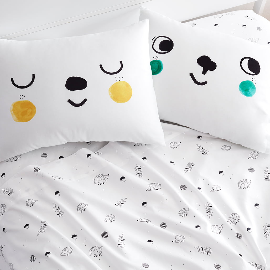 Children's bedding set with smiley face pillows and patterned sheet