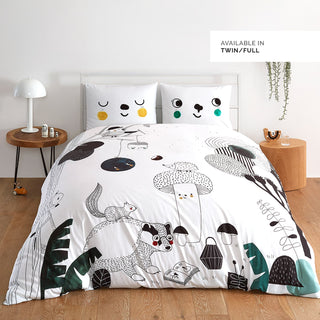 Bedding set with animal and nature-themed design on a bed in a room setting.