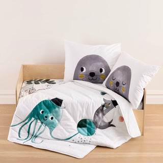 Children's bedding set with seal and octopus design on a bed.