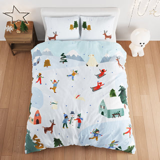 Children's bedding set with winter scene design on a bed in a bedroom.
