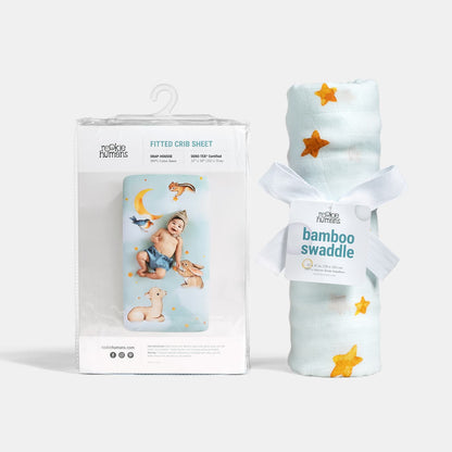 Baby swaddle and fitted crib sheet with packaging on a white background