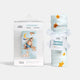 Baby swaddle and fitted crib sheet with packaging on a white background